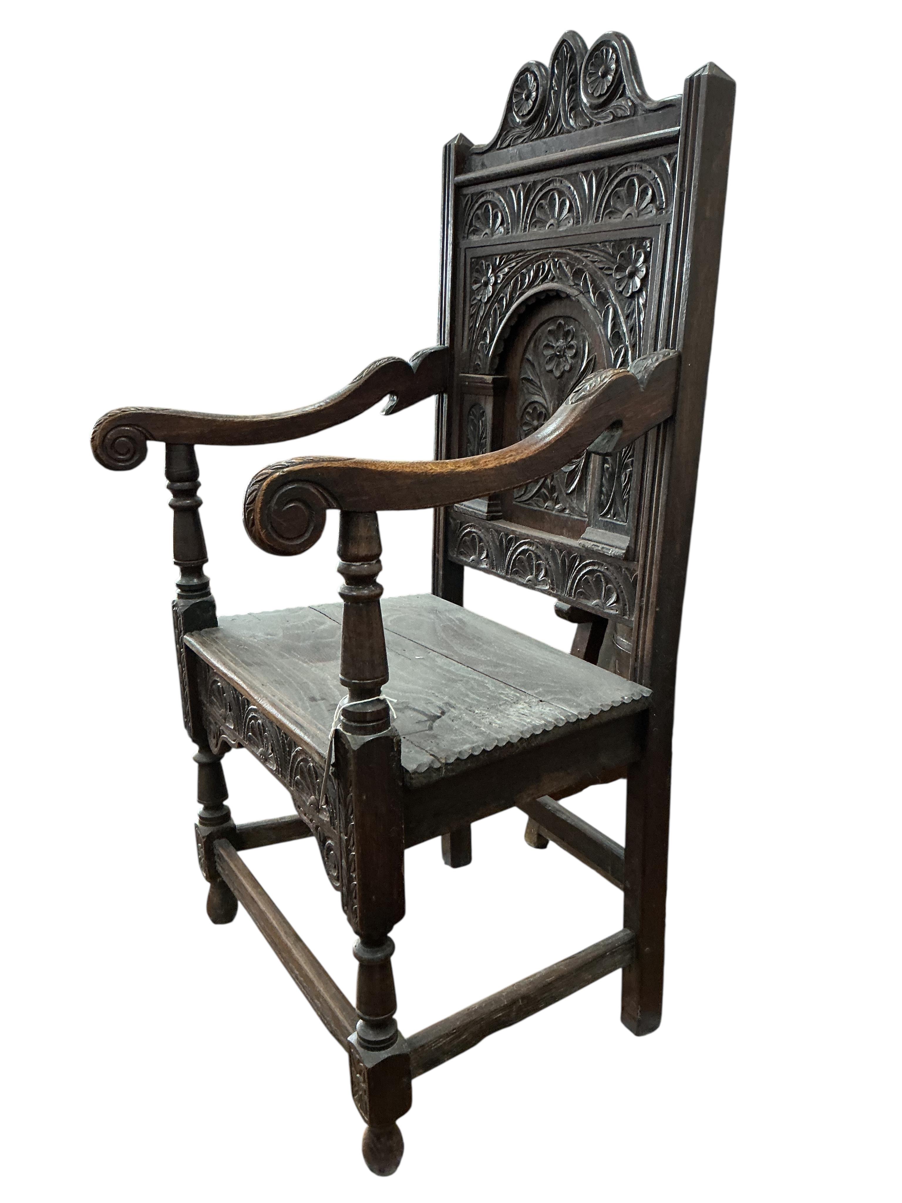 An 18th century style carved oak wainscot chair, width 57cm, depth 43cm, height 120cm